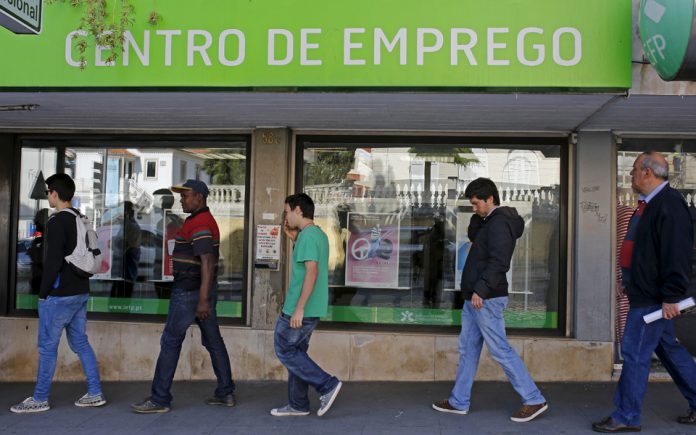 People wait at the employment center to open in Sintra